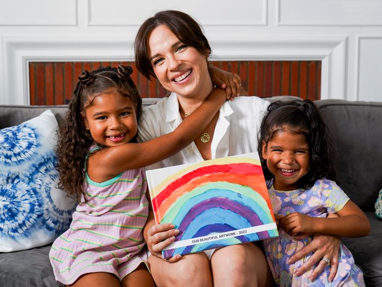 A teacher handing a Kids Art Book to a student